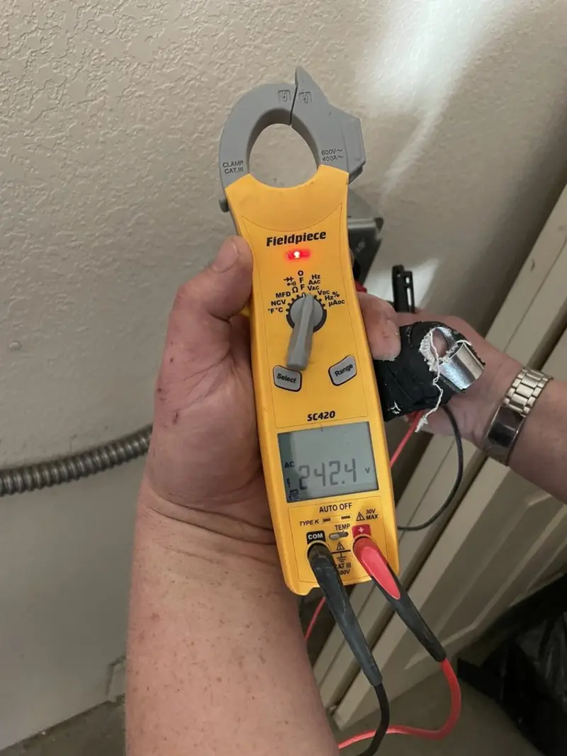 Voltage testing with clamp meter during Ceiling Fan Installation in Perry